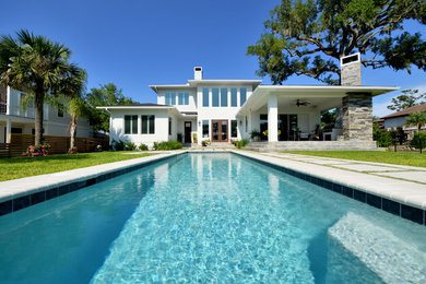 Hot tub - large modern backyard concrete paver and rectangular lap hot tub idea in Jacksonville