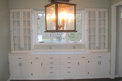 Example of a mid-sized classic dark wood floor enclosed dining room design in Minneapolis with green walls