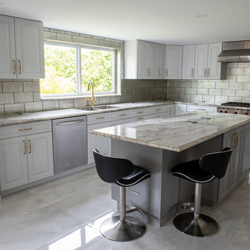 Transitional Kitchen Done in a 2 Tone Color With Integrated Dining Table