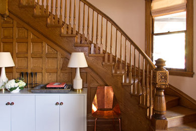 Example of a mid-sized minimalist medium tone wood floor and brown floor foyer design in Chicago with pink walls