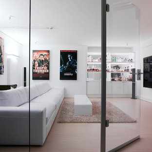 Mid-sized trendy enclosed light wood floor home theater photo in Stuttgart with white walls and a wall-mounted tv