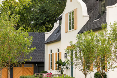 Inspiration for a small eclectic white two-story stucco exterior home remodel in Minneapolis with a shingle roof