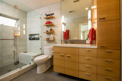 Alcove shower - contemporary 3/4 gray tile gray floor alcove shower idea in Los Angeles with flat-panel cabinets, medium tone wood cabinets, an undermount sink and beige countertops