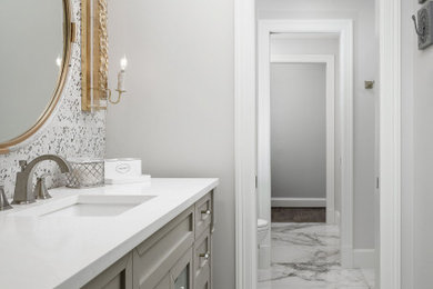 Bathroom - small contemporary gray tile and stone tile marble floor, gray floor, single-sink and wallpaper bathroom idea in Dallas with recessed-panel cabinets, gray cabinets, a two-piece toilet, gray walls, an undermount sink, quartzite countertops, white countertops and a freestanding vanity