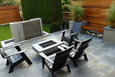 Mid-sized arts and crafts backyard stone patio fountain photo in Vancouver with no cover