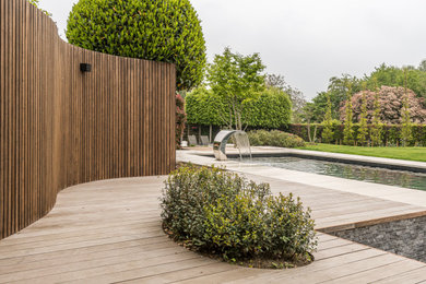 Design ideas for a large scandinavian back full sun garden fence for spring in Buckinghamshire with decking and a wood fence.