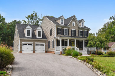 Example of a large classic beige three-story vinyl exterior home design in Baltimore with a shingle roof