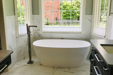 Mid-sized transitional master white tile and marble tile marble floor and white floor bathroom photo in Wichita with shaker cabinets, black cabinets, a two-piece toilet, green walls, an undermount sink, a hinged shower door and gray countertops