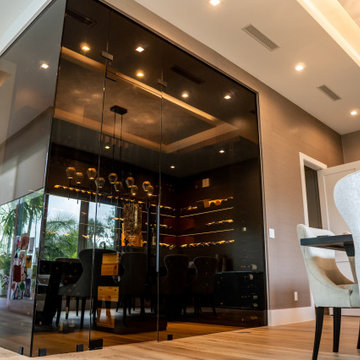 A Tinted Glass Wine Cellar Separating the Living and Dining Room