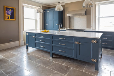 Inspiration for a mid-sized transitional single-wall open plan kitchen in Wiltshire with limestone floors and with island.