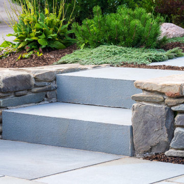 Bluestone steps set into a dry-laid fieldstone wall