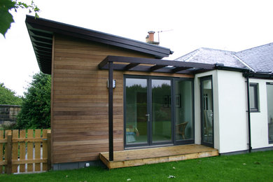 Design ideas for a small and white contemporary bungalow detached house in Edinburgh with wood cladding, a lean-to roof and a mixed material roof.