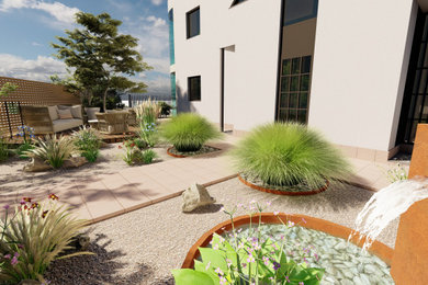 Immagine di un giardino formale industriale esposto a mezz'ombra di medie dimensioni e davanti casa in estate con fontane, pavimentazioni in pietra naturale e recinzione in legno