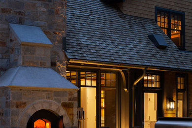 Mid-sized arts and crafts side yard stone patio photo in Milwaukee with a fireplace and no cover