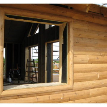 D trim hewn window trim with half log siding