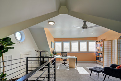 Example of a mid-sized trendy freestanding desk carpeted, gray floor and vaulted ceiling study room design in DC Metro with orange walls