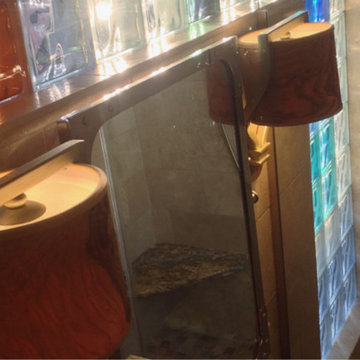 Olive wood bathroom vanity fixtures aournd travertine walls