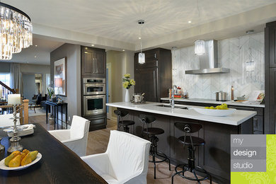 Eat-in kitchen - mid-sized contemporary single-wall eat-in kitchen idea in Toronto with a double-bowl sink, shaker cabinets, dark wood cabinets, quartz countertops, white backsplash, stone tile backsplash, paneled appliances and an island