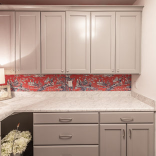 他の地域の中サイズのトラディショナルスタイルのおしゃれな洗濯室 (ドロップインシンク、落し込みパネル扉のキャビネット、ベージュのキャビネット、ラミネートカウンター、赤い壁、磁器タイルの床、左右配置の洗濯機・乾燥機、ベージュの床、ベージュのキッチンカウンター) の写真