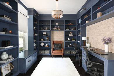 Study room - small coastal built-in desk dark wood floor, brown floor and wallpaper study room idea in Houston with blue walls and no fireplace