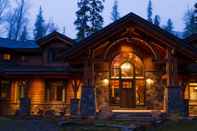 Photo of a large arts and crafts two-storey house exterior in Other with mixed siding, a gable roof and a shingle roof.