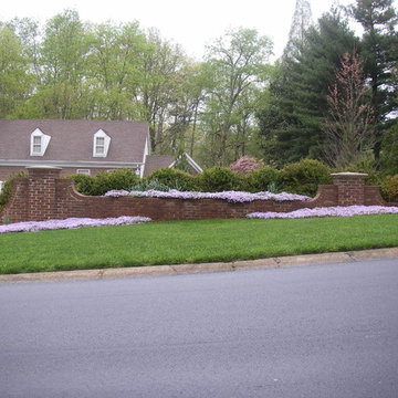 Brick walls near street provide interest when house sits lower than street
