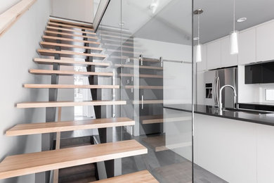 Staircase - mid-sized modern wooden straight open and wood railing staircase idea in Calgary