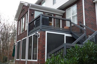 Example of a large red two-story mixed siding exterior home design in Charlotte with a hip roof