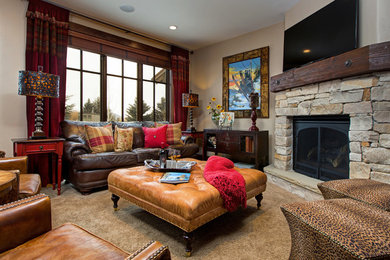 Example of a mountain style carpeted family room design in Salt Lake City with beige walls, a standard fireplace, a stone fireplace and a tv stand