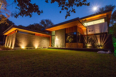 Example of a large trendy brown two-story mixed siding exterior home design in Austin with a metal roof