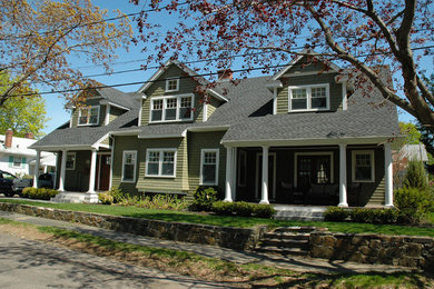 Mid-sized traditional green two-story wood exterior home idea in Boston with a shingle roof