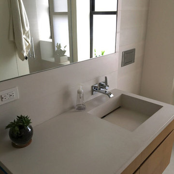 Concrete bathroom finishes - tiles, floor, sink.Private residence - Manhattan.
