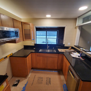 Kitchen remodel with newly installed black granite tops