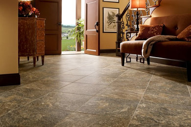 Example of a mid-sized classic ceramic tile and gray floor entryway design in New York with beige walls and a brown front door