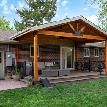 Boulder Patio Cover with Deckorators Decking and Railing and Stamped Concrete