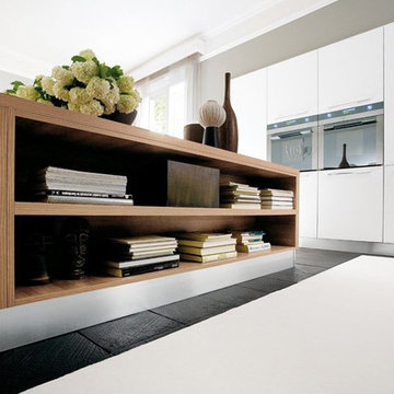 Modern white kitchen with medium wood double sided island