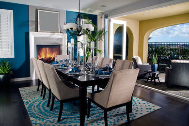 Inspiration for a mid-sized contemporary separate dining room in Charlotte with blue walls, dark hardwood floors, a standard fireplace and a tile fireplace surround.