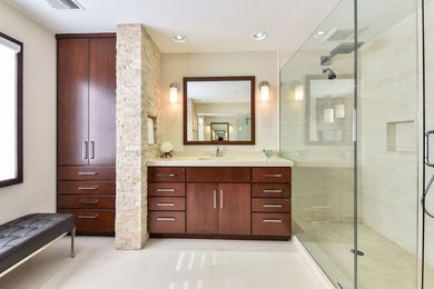 Inspiration for a mid-sized contemporary master beige tile and stone tile travertine floor and beige floor alcove shower remodel in DC Metro with flat-panel cabinets, medium tone wood cabinets, a two-piece toilet, beige walls, an undermount sink, quartz countertops and a hinged shower door