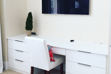 Example of a large minimalist guest carpeted bedroom design in New Orleans with white walls and no fireplace