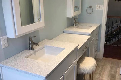 Mid-sized transitional master medium tone wood floor and brown floor bathroom photo in New York with shaker cabinets, white cabinets, gray walls and an undermount sink