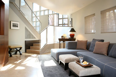 Family room - mid-sized modern family room idea in Chicago with beige walls and a media wall