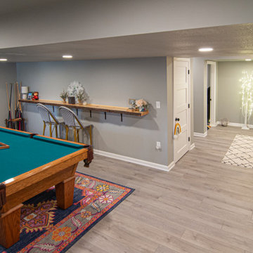 Basement Utilizing Open Space to Shoot Pool and Watch Favorite Sports Team