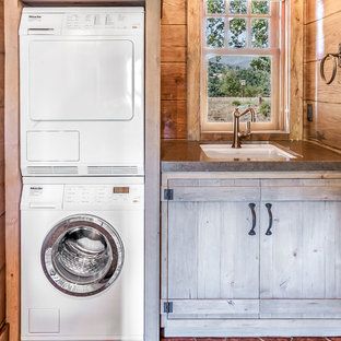 Design ideas for a medium sized rustic single-wall separated utility room in San Francisco with a single-bowl sink, light wood cabinets, copper worktops, brown walls, ceramic flooring and a stacked washer and dryer.