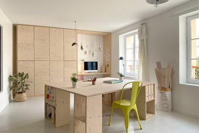 Aménagement d'un grand bureau atelier scandinave avec un mur blanc, parquet peint, un bureau intégré et un sol blanc.