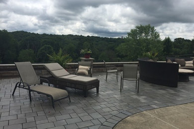 Example of a mid-sized trendy backyard tile patio design in Other with no cover