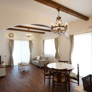 Photo of a romantic open plan living room in Other with white walls, dark hardwood flooring, no fireplace, a freestanding tv and brown floors.