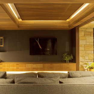 Large contemporary enclosed home cinema in Sydney with grey walls, slate flooring and a wall mounted tv.