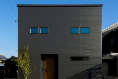 Modelo de fachada de casa negra y azul de dos plantas con tejado de un solo tendido, tejado de metal y revestimiento de metal