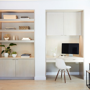 Design ideas for a contemporary study room in San Francisco with white walls, light hardwood floors, a built-in desk and beige floor.