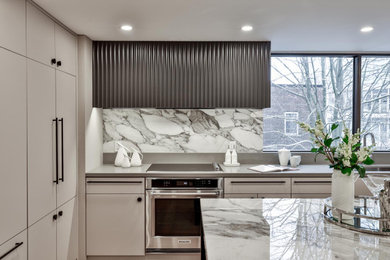 Mid-sized contemporary l-shaped open plan kitchen in Toronto with an undermount sink, flat-panel cabinets, beige cabinets, quartz benchtops, grey splashback, marble splashback, stainless steel appliances, light hardwood floors, with island, beige floor and grey benchtop.